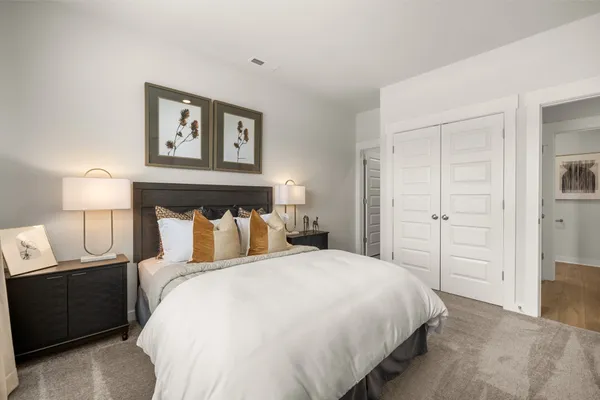 a bedroom with a bed and a night stand