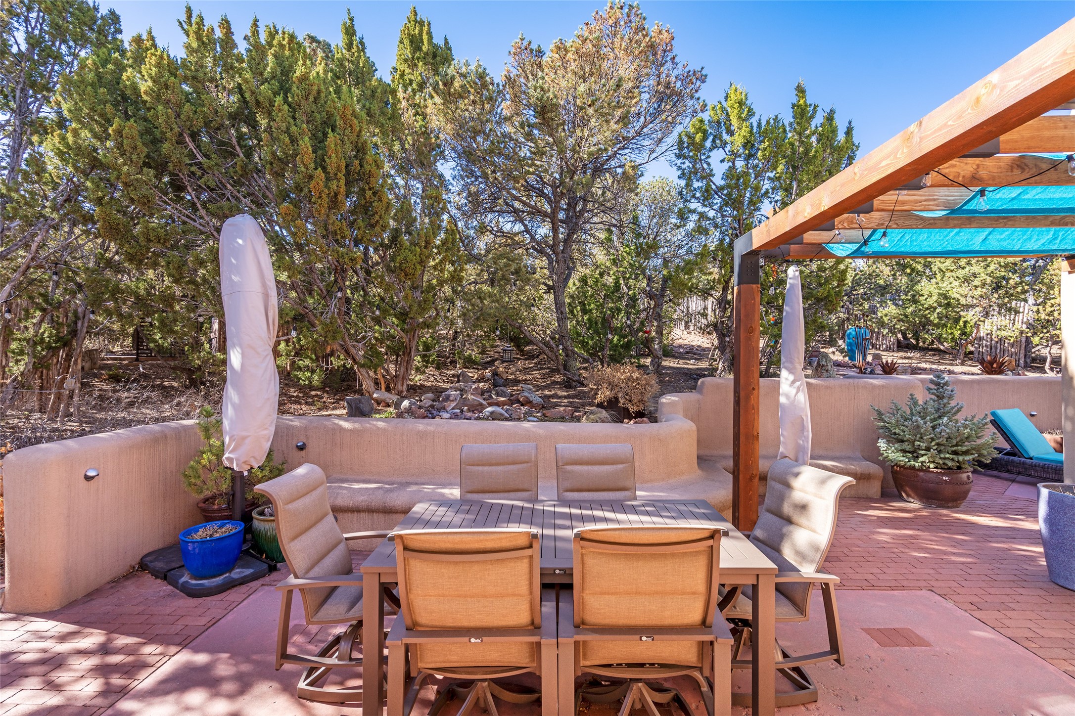 1204 Bandolina Road Santa Fe, NM 87501 - Photo 27 of 69 Back patio; bench seating along wall