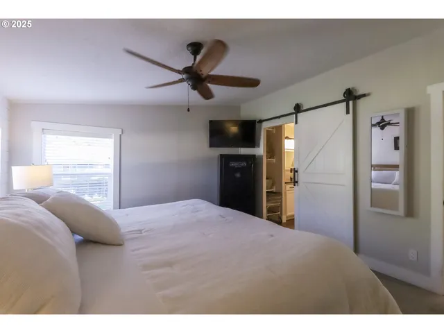 a bedroom with a bed and a large mirror