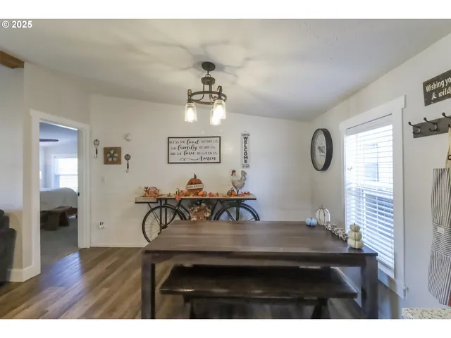 a view of a livingroom and a dining room with furniture window and wooden floor