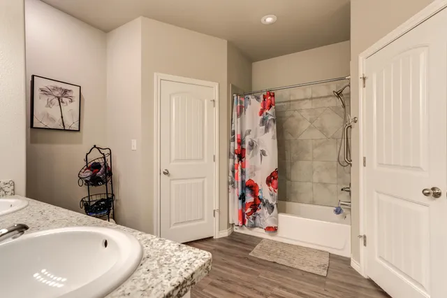a bathroom with a bathtub and a shower