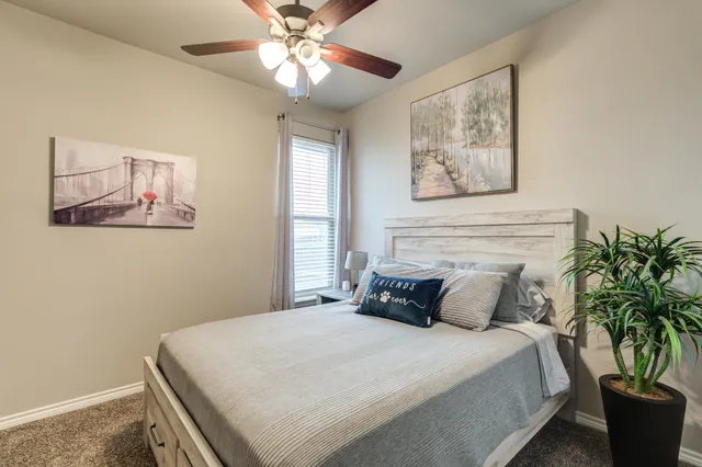 a bedroom with a large bed and a chandelier