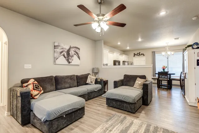 a living room with furniture and wooden floor
