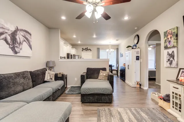 a living room with furniture and wooden floor