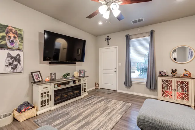 a living room with furniture and a flat screen tv