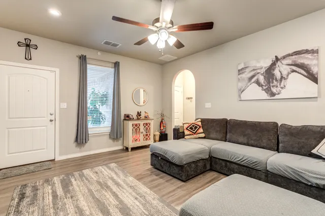 a living room with furniture and a chandelier