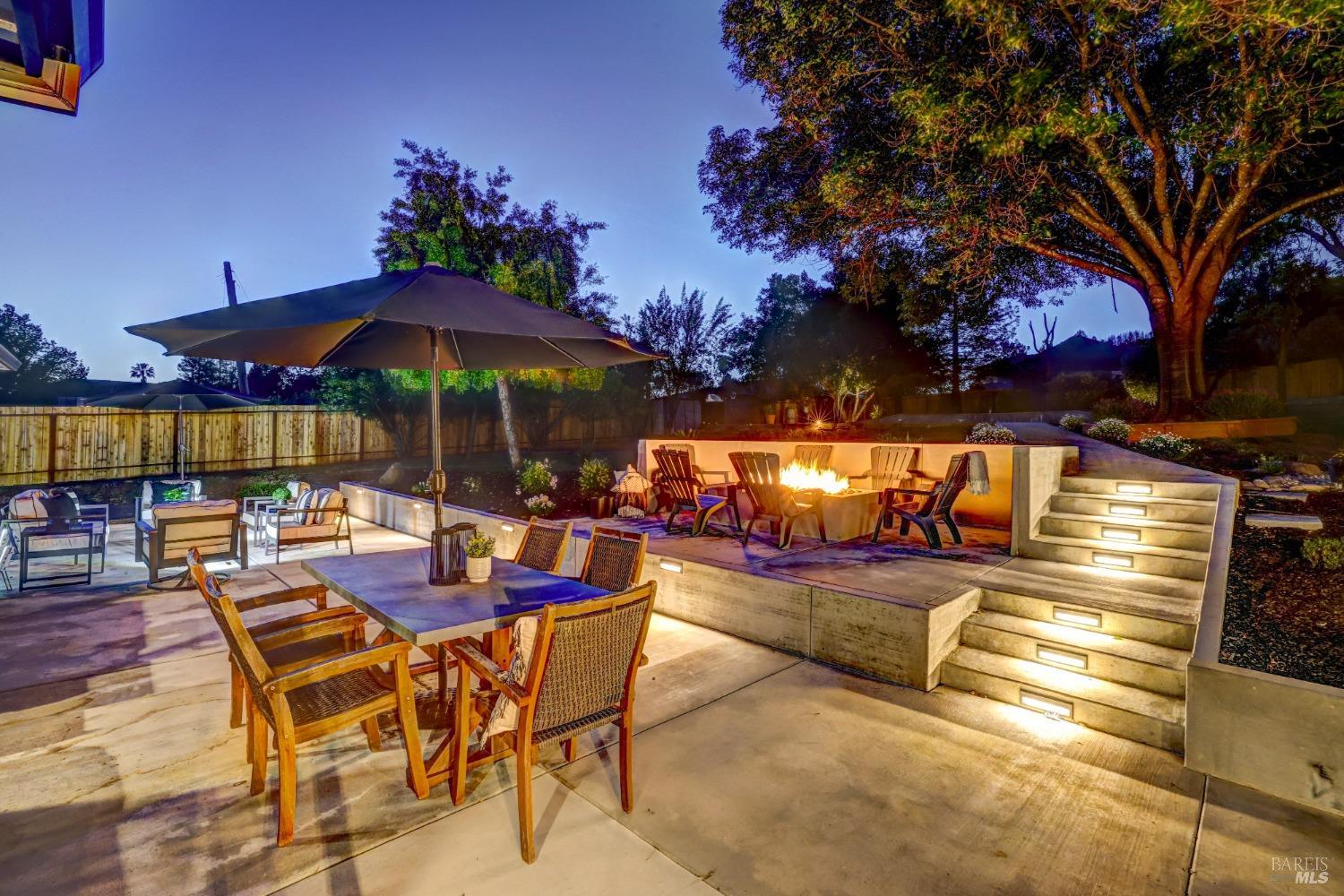 5511 Monte Verde Drive Santa Rosa, CA 95409 - Photo 1 of 1 a view of a patio with dining table and chairs under an umbrella with a barbeque