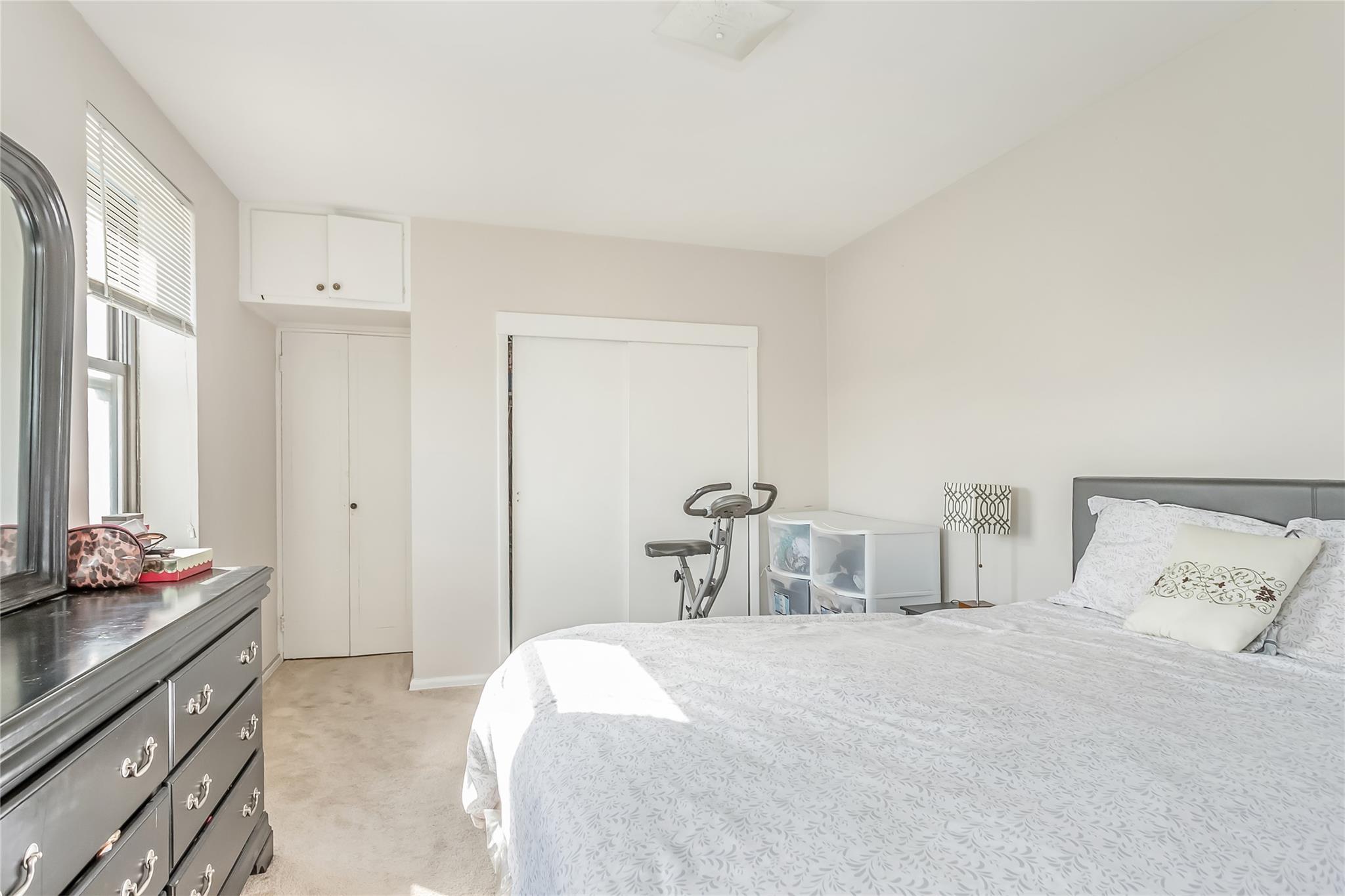 32-22 92nd Street, Unit 603 Queens, NY 11369 - Photo 15 of 25 a bedroom with a bed and a cabinets