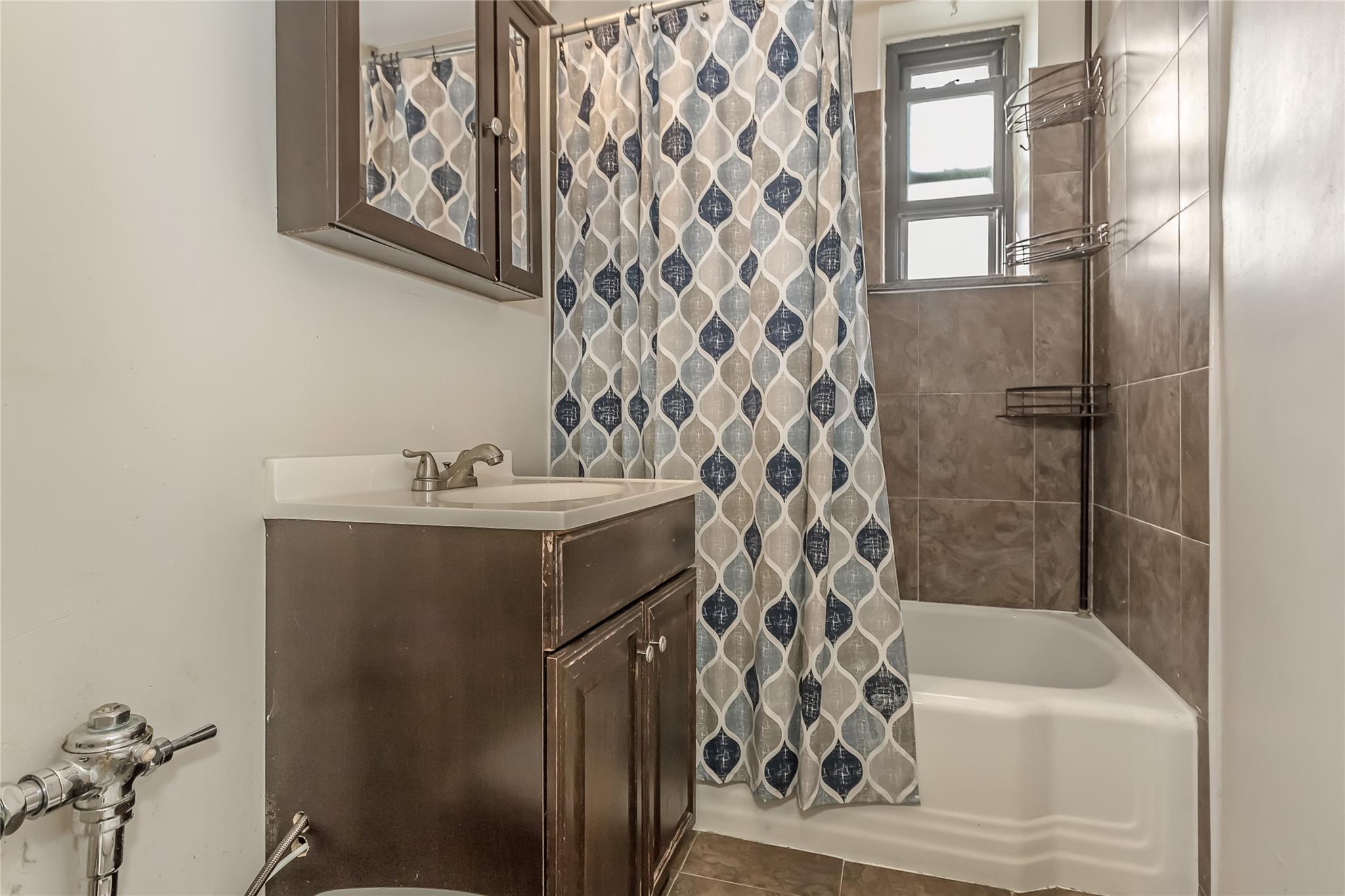 32-22 92nd Street, Unit 603 Queens, NY 11369 - Photo 21 of 25 a bathroom with a sink and a bathtub