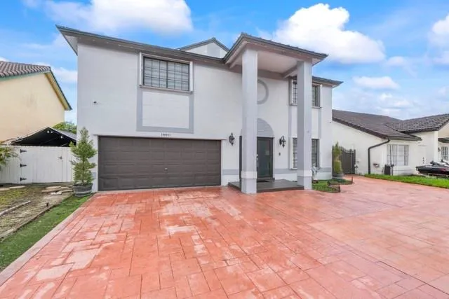 a view of a house with a yard and garage