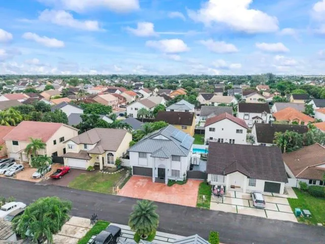 an aerial view of residential houses with outdoor space