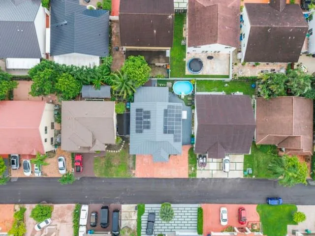 an aerial view of residential houses with outdoor space