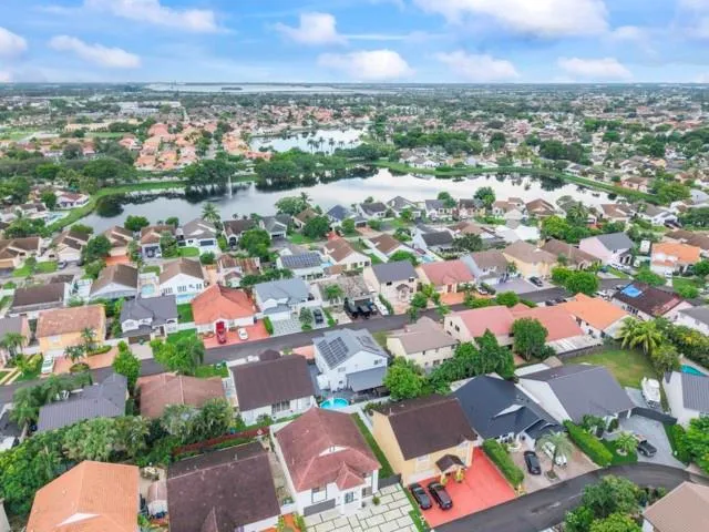 an aerial view of a house with swimming pool and a garden view