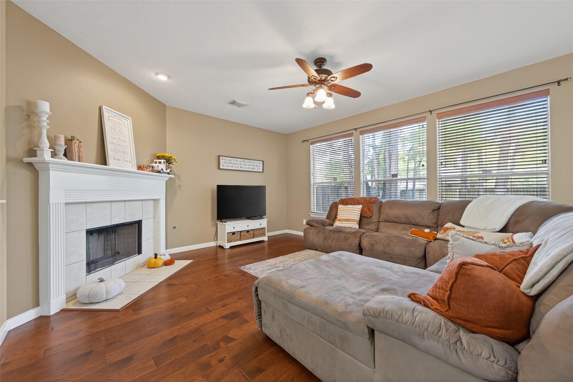 59 Genesee Ridge Drive Conroe, TX 77385 - Photo 12 of 44 a living room with furniture a fireplace and a flat screen tv