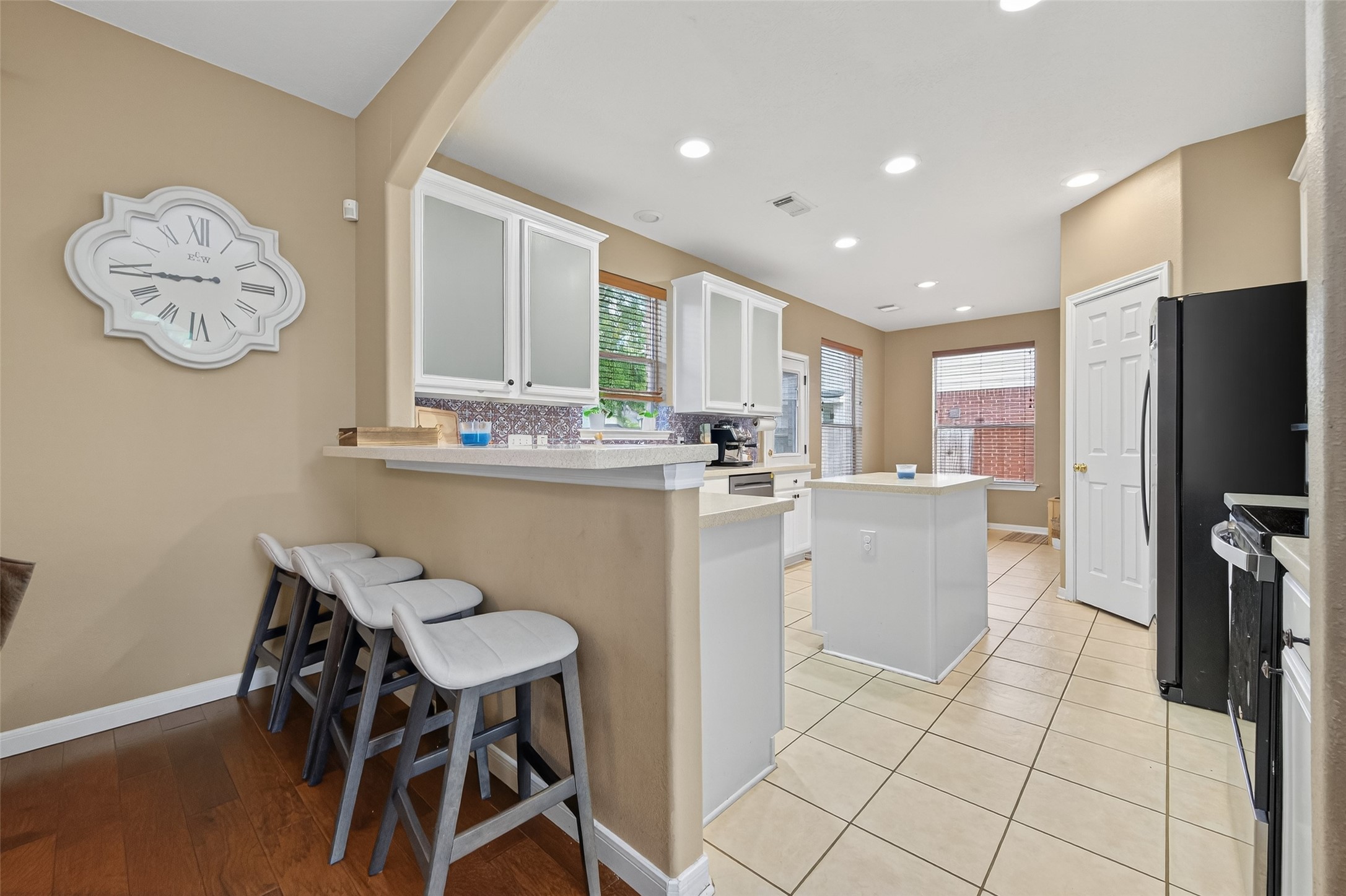 59 Genesee Ridge Drive Conroe, TX 77385 - Photo 15 of 44 a kitchen with a dining table chairs and refrigerator