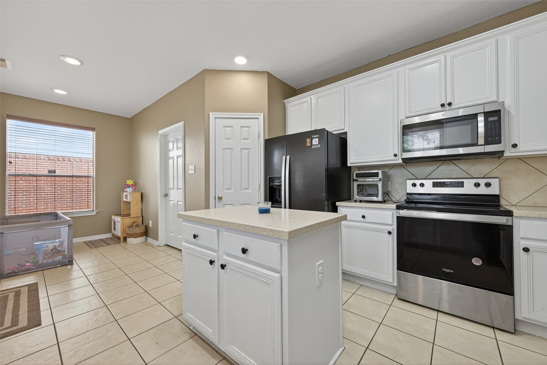 59 Genesee Ridge Drive Conroe, TX 77385 - Photo 17 of 44 a kitchen with stainless steel appliances a stove refrigerator sink and cabinets