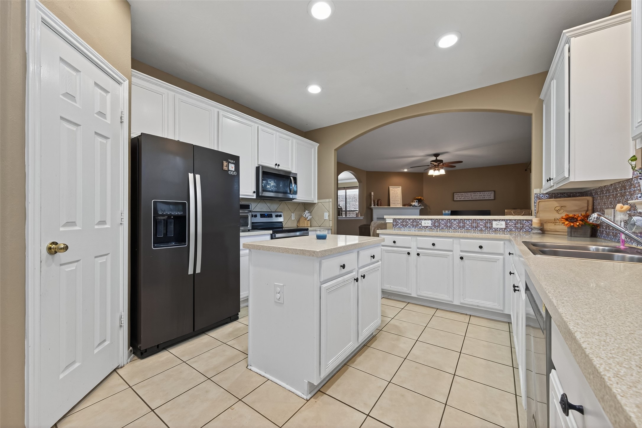 59 Genesee Ridge Drive Conroe, TX 77385 - Photo 18 of 44 a kitchen with white cabinets and stainless steel appliances