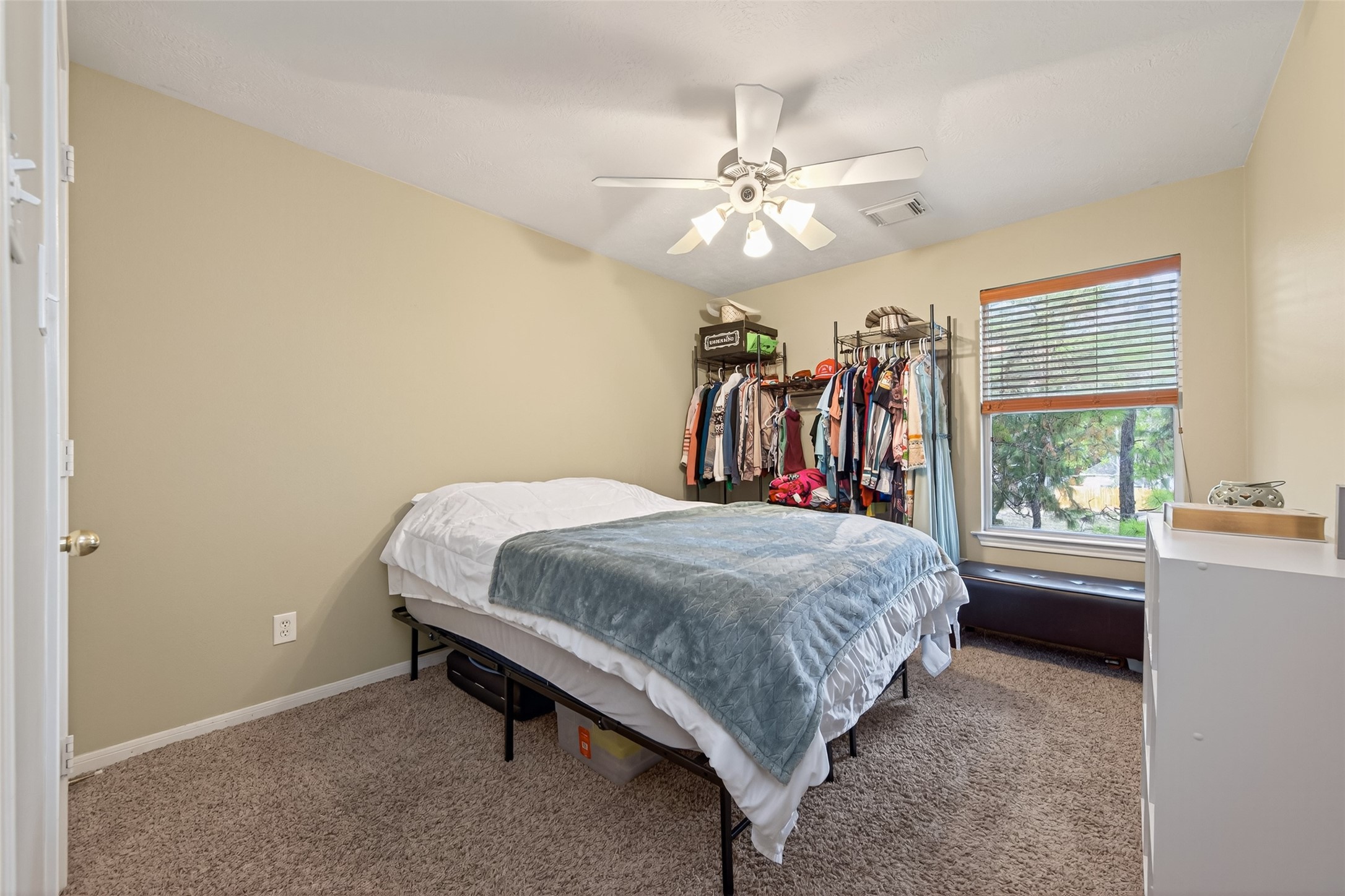 59 Genesee Ridge Drive Conroe, TX 77385 - Photo 27 of 44 a bed room with a bed and a window