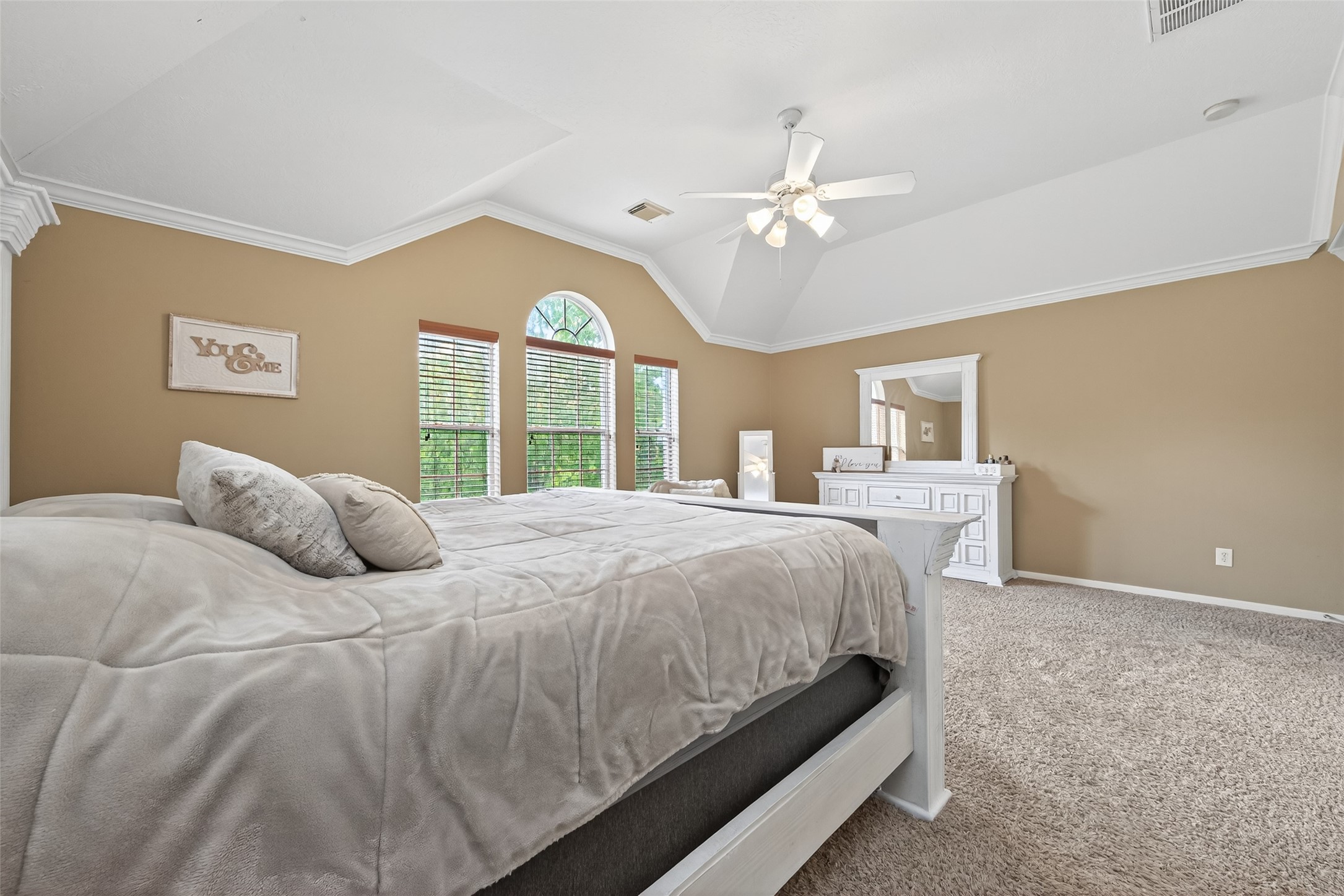 59 Genesee Ridge Drive Conroe, TX 77385 - Photo 33 of 44 a bedroom with a large bed and a chandelier