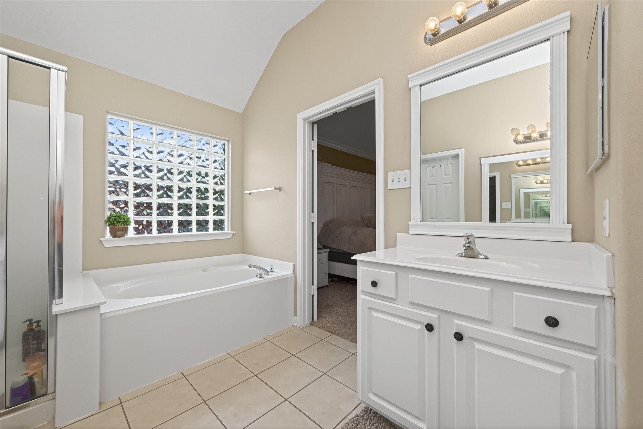 59 Genesee Ridge Drive Conroe, TX 77385 - Photo 37 of 44 a bathroom with a bathtub sink and mirror