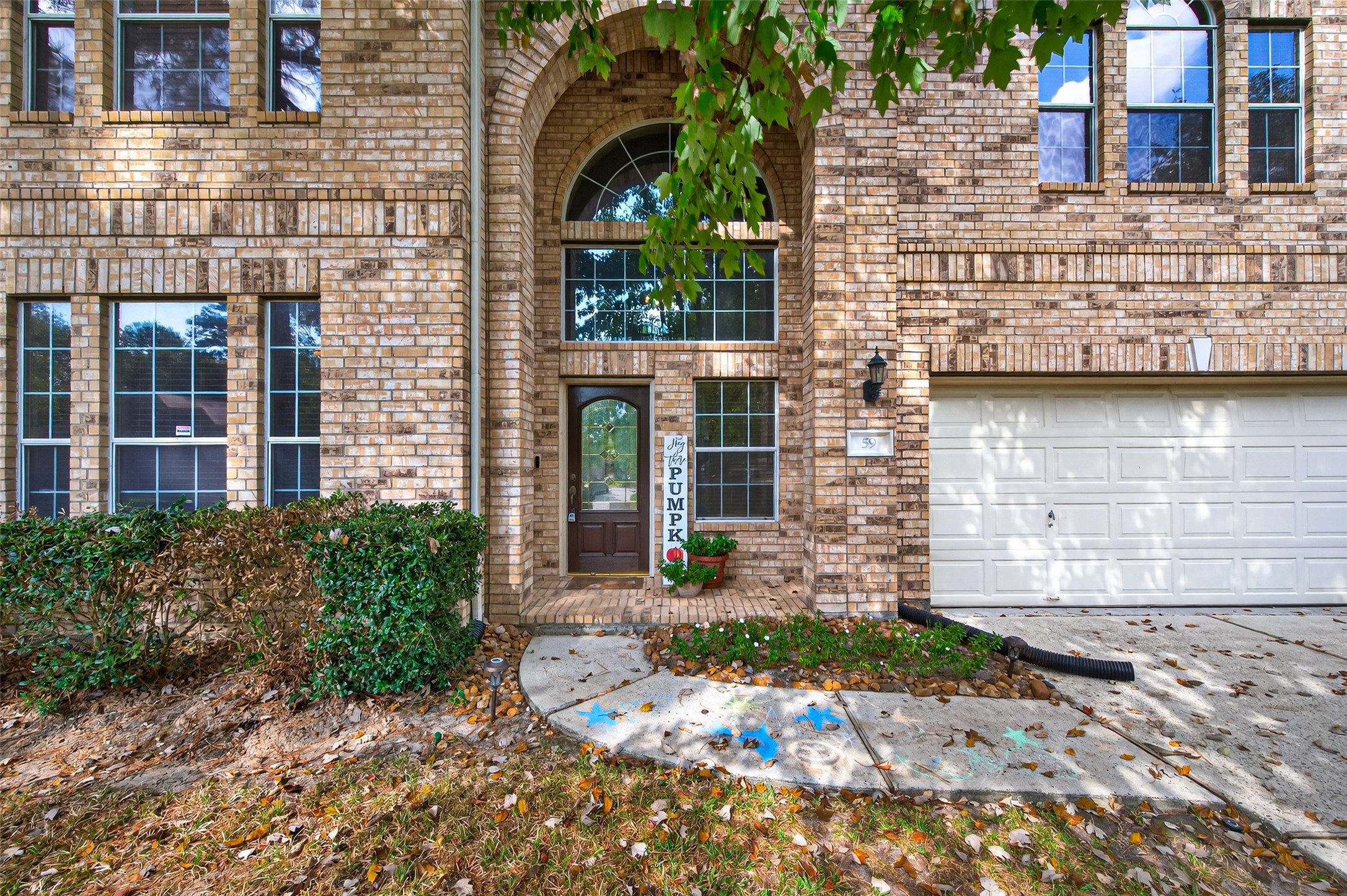 59 Genesee Ridge Drive Conroe, TX 77385 - Photo 6 of 44 front view of a brick house with a yard
