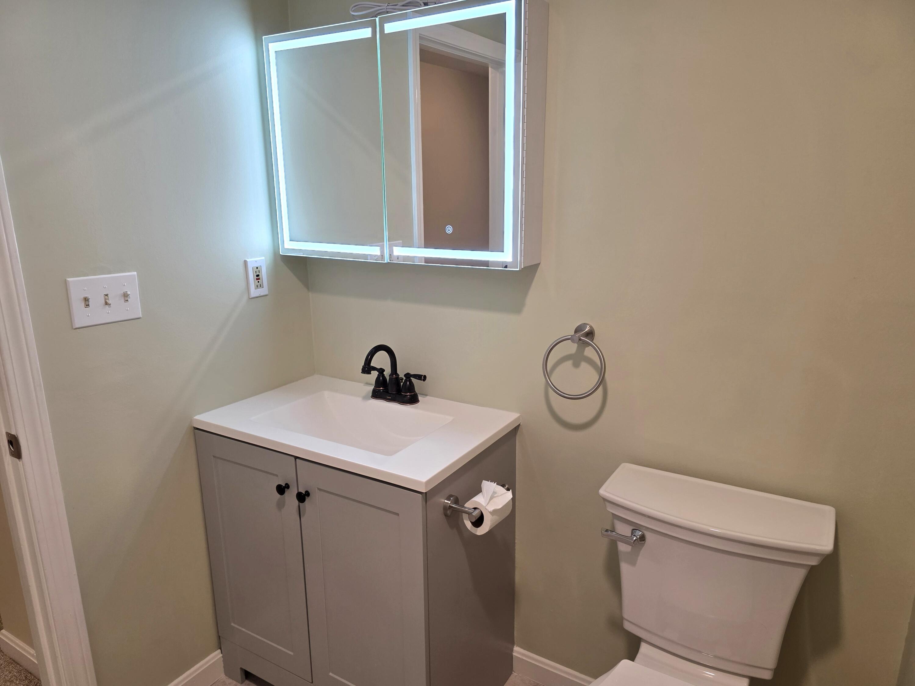 720 Pitchers Way, Unit F52 Hyannis, MA 02601 - Photo 12 of 25 a bathroom with a toilet sink and mirror