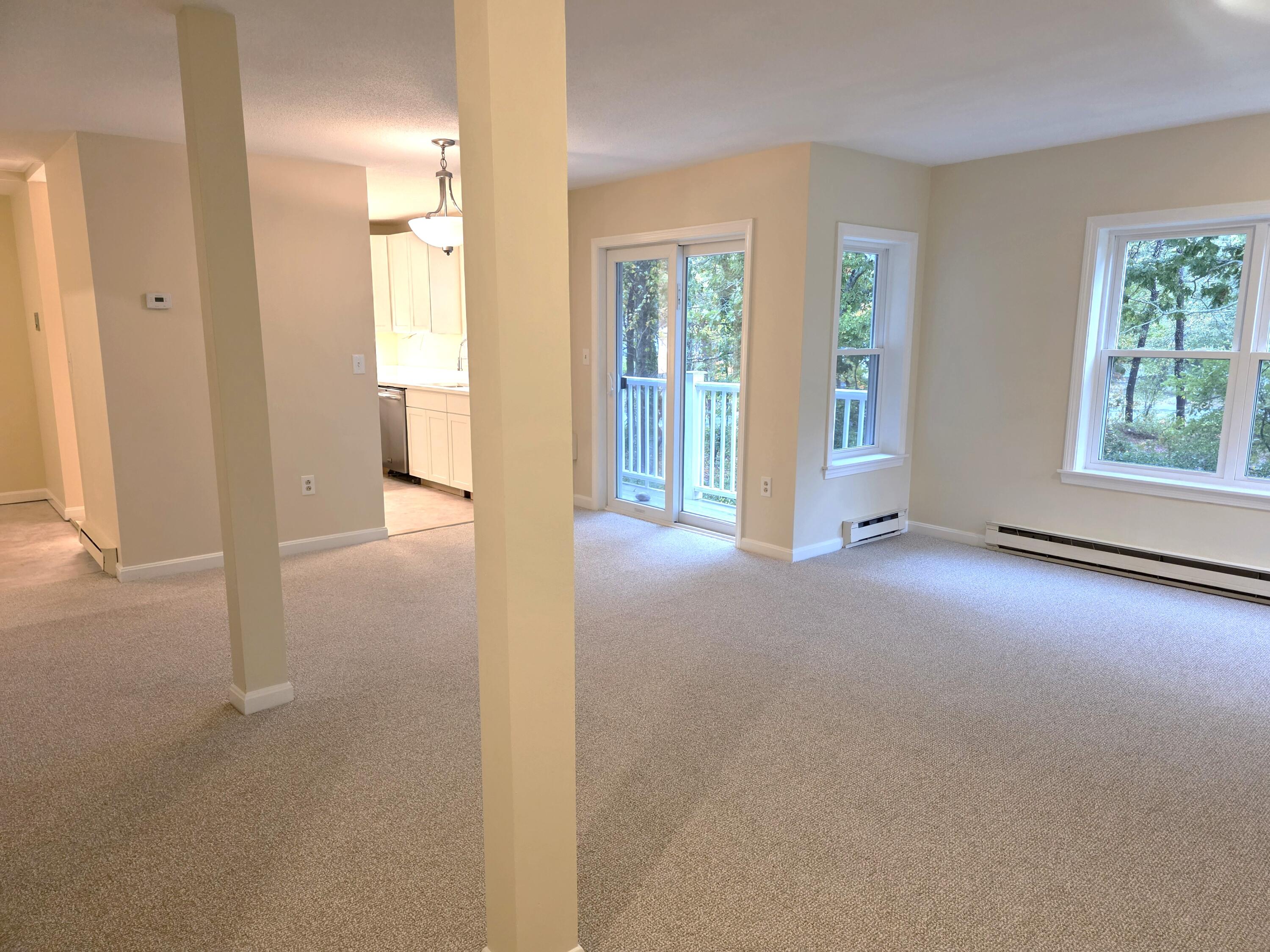 720 Pitchers Way, Unit F52 Hyannis, MA 02601 - Photo 15 of 25 an empty room with windows and entrance to other room