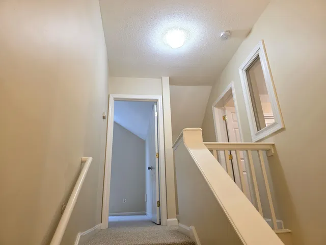 an empty room with a large window and a balcony