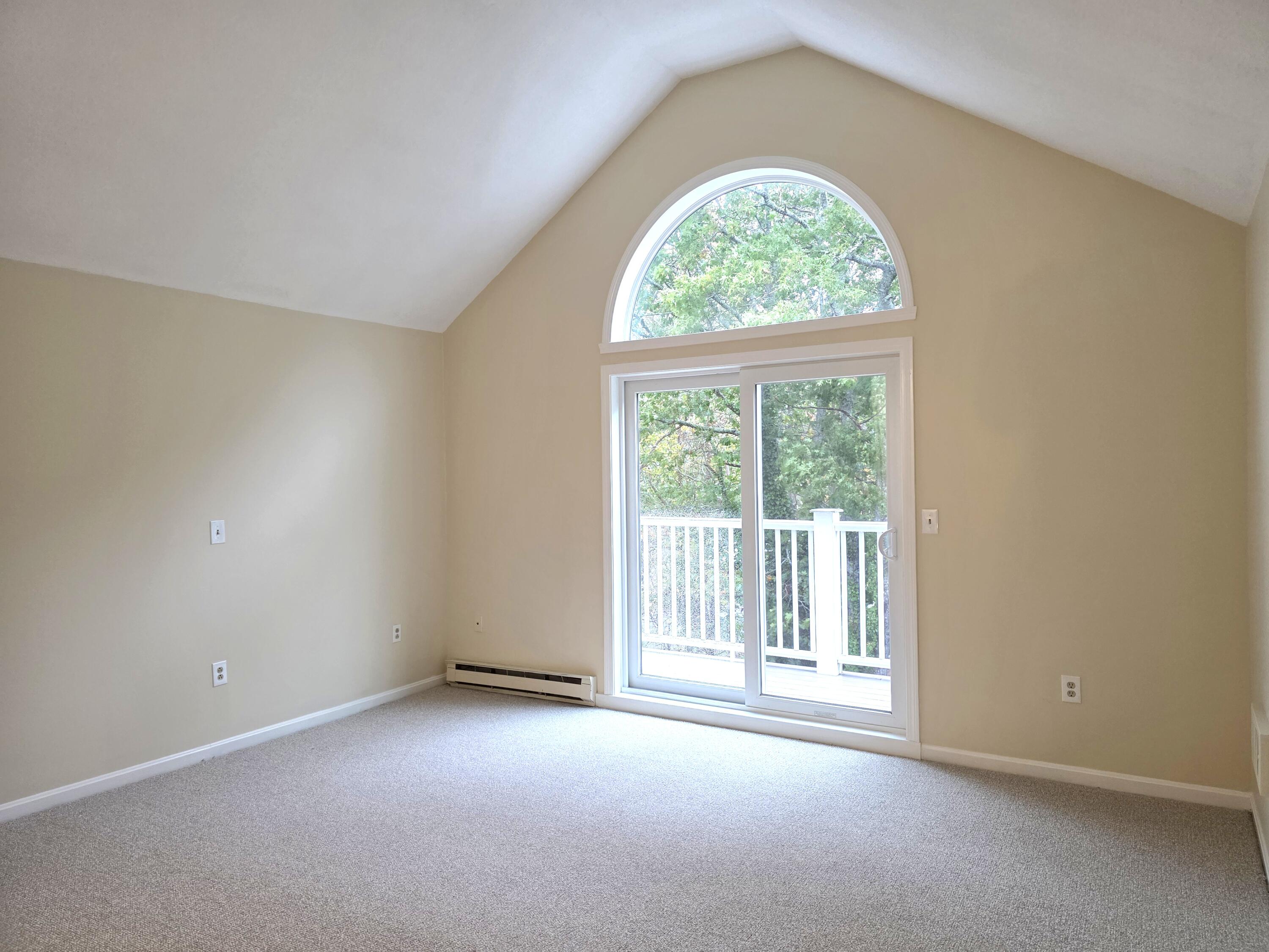 720 Pitchers Way, Unit F52 Hyannis, MA 02601 - Photo 18 of 25 an empty room with a large window and a balcony