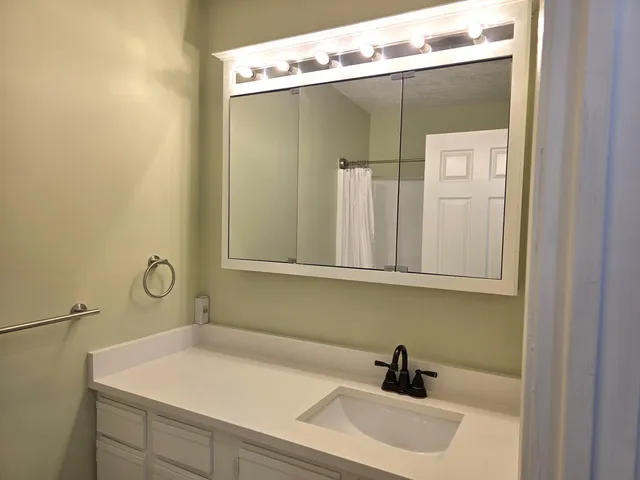 a bathroom with a shower and a glass door