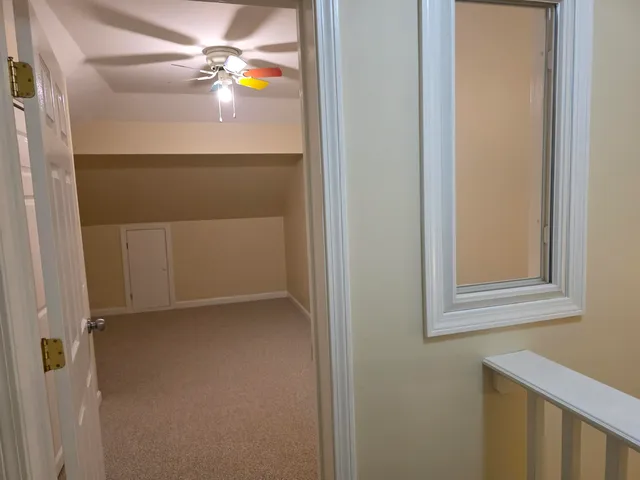 an empty room with closet and windows