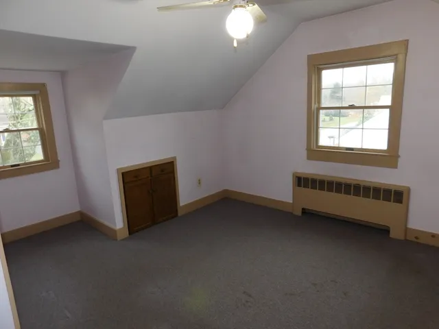 a bathroom with a tub a sink and a window