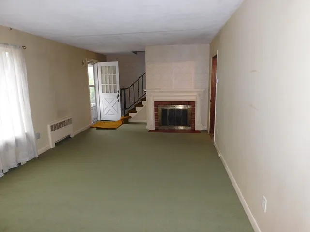 a large kitchen with a large counter top space a sink and stainless steel appliances