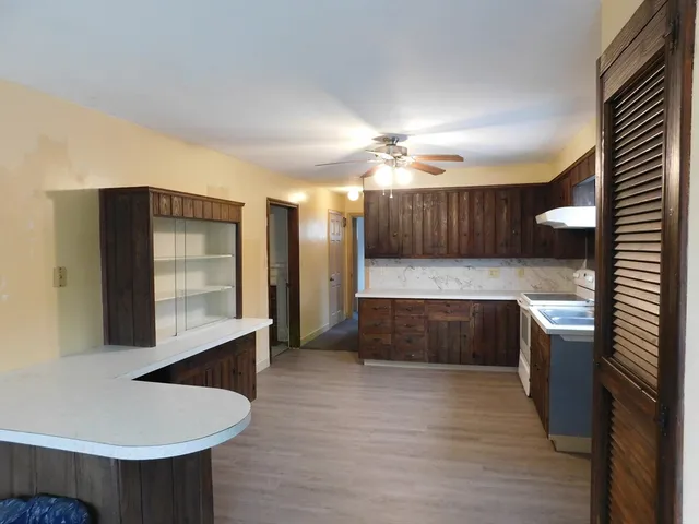 a large kitchen with a large counter top appliances and cabinets