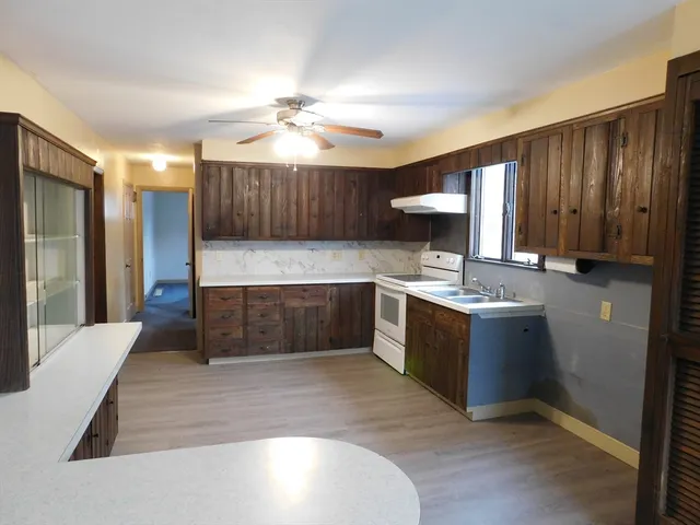 a kitchen with a stove oven and a sink
