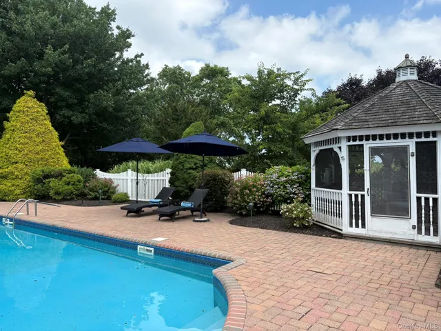 swimming pool view with a seating space