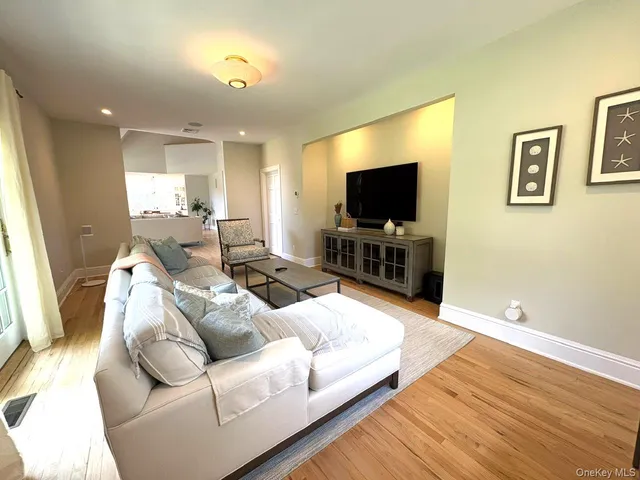 a spacious bedroom with a bed and a dresser