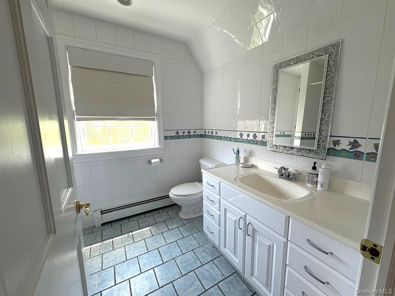 365 Chablis Path Southold, NY 11971 - Photo 18 of 30 a bathroom with a sink a toilet and mirror