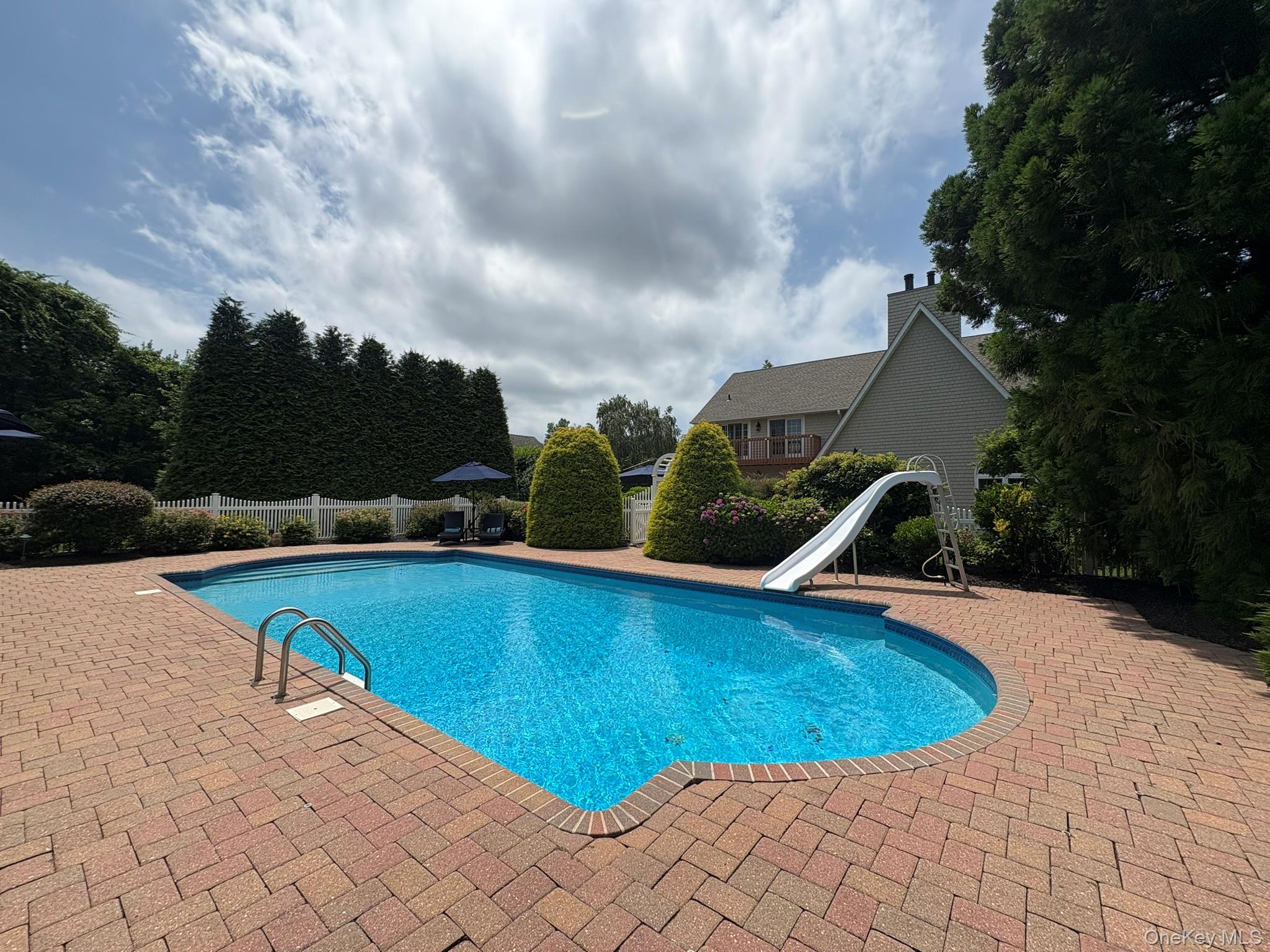 365 Chablis Path Southold, NY 11971 - Photo 21 of 30 a view of a swimming pool with an outdoor seating