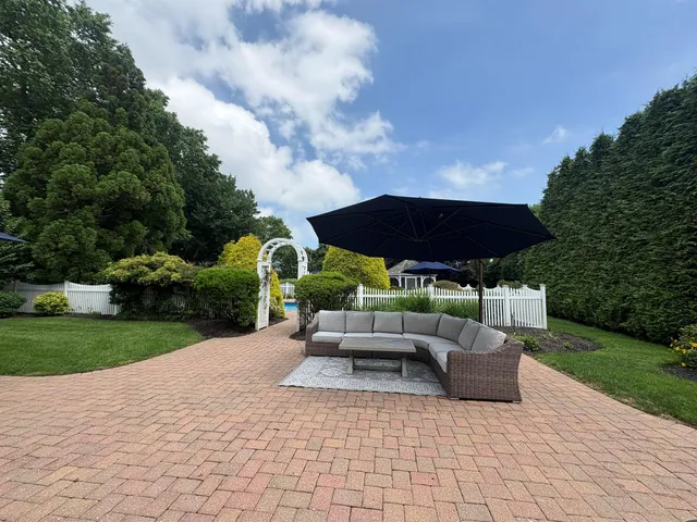 a view of a backyard with sitting area and entertaining space