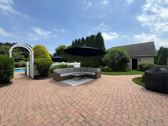 an aerial view of a house with a yard and large trees