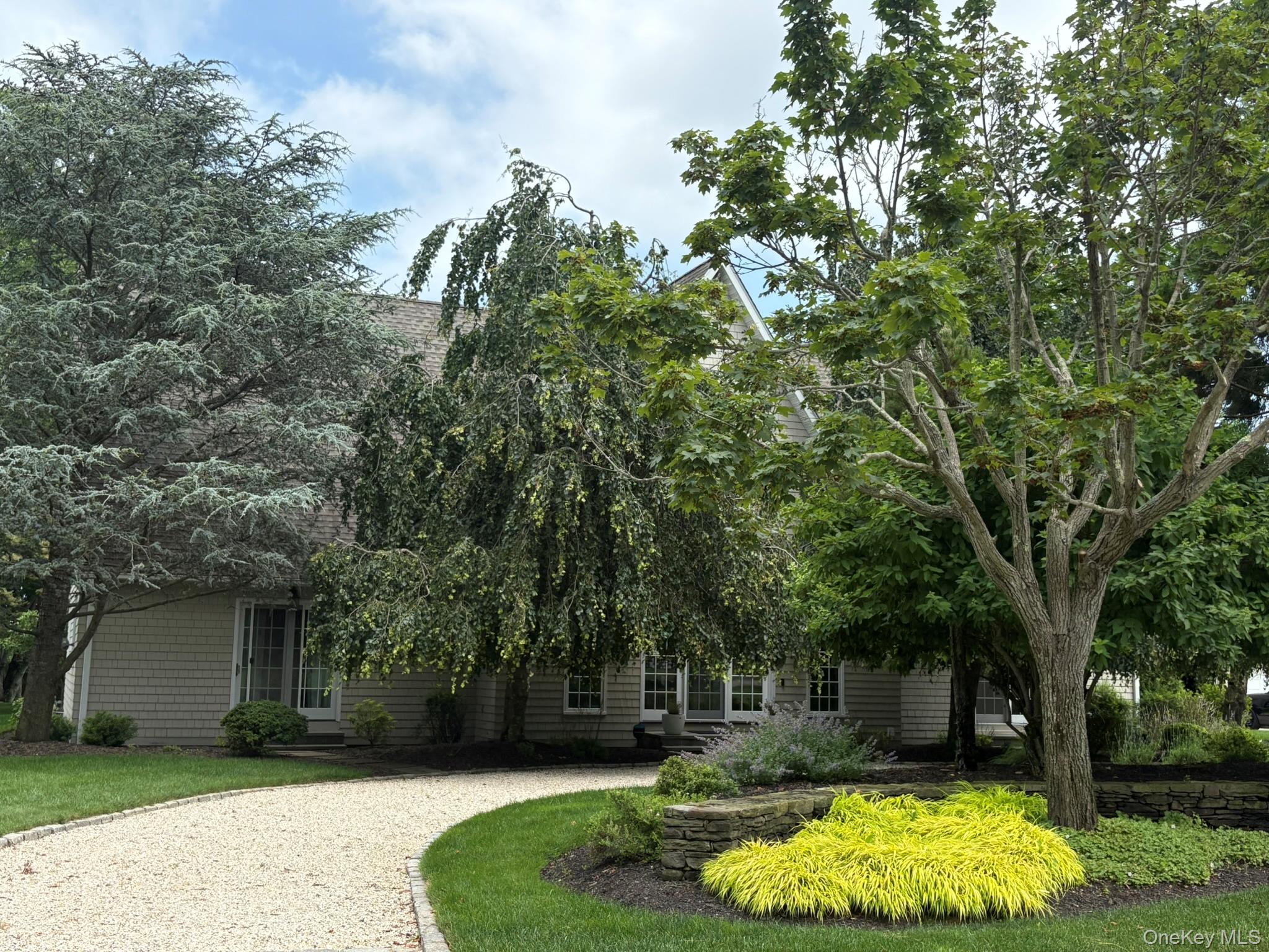 365 Chablis Path Southold, NY 11971 - Photo 28 of 30 a view of a backyard with large trees