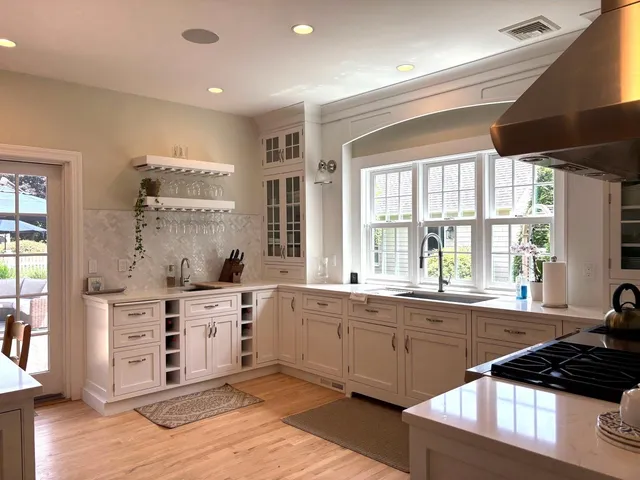 a kitchen with stainless steel appliances a sink stove and window