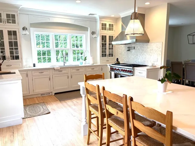 a kitchen with stainless steel appliances kitchen island granite countertop a stove a sink and a refrigerator