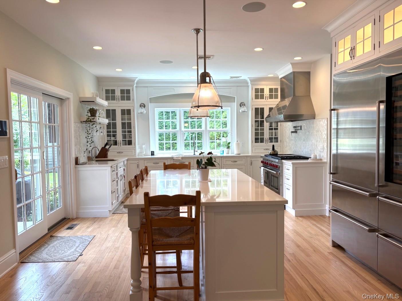365 Chablis Path Southold, NY 11971 - Photo 7 of 30 a kitchen with stainless steel appliances granite countertop a refrigerator a stove and a wooden floors