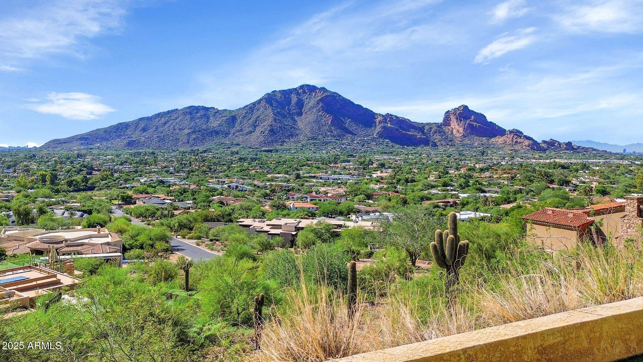 7040 North Invergordon Road Paradise Valley, AZ 85253 - Photo 2 of 11 a view of a lush green hillside and a houses