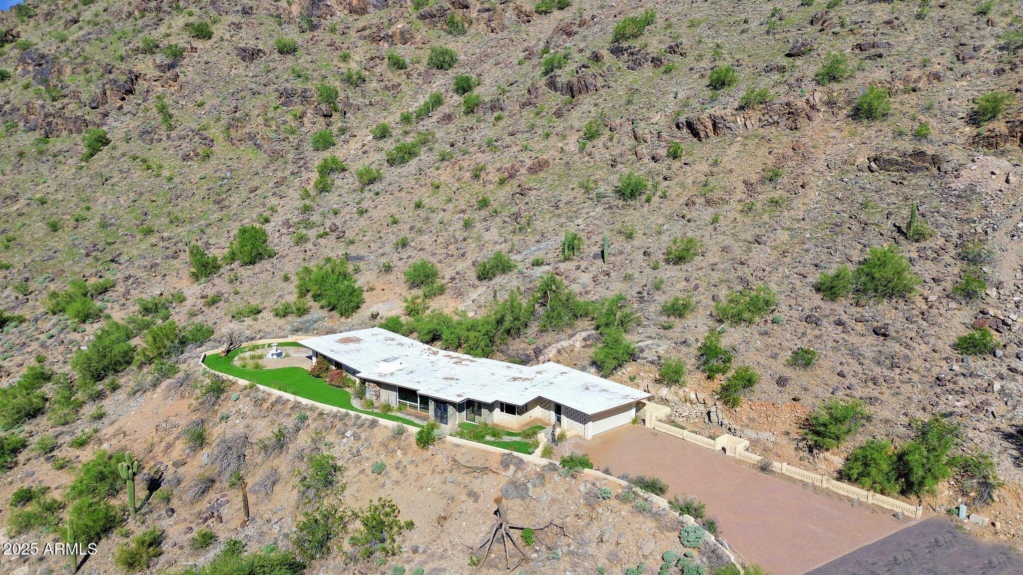 7040 North Invergordon Road Paradise Valley, AZ 85253 - Photo 5 of 11 a view of a dry yard with a barn