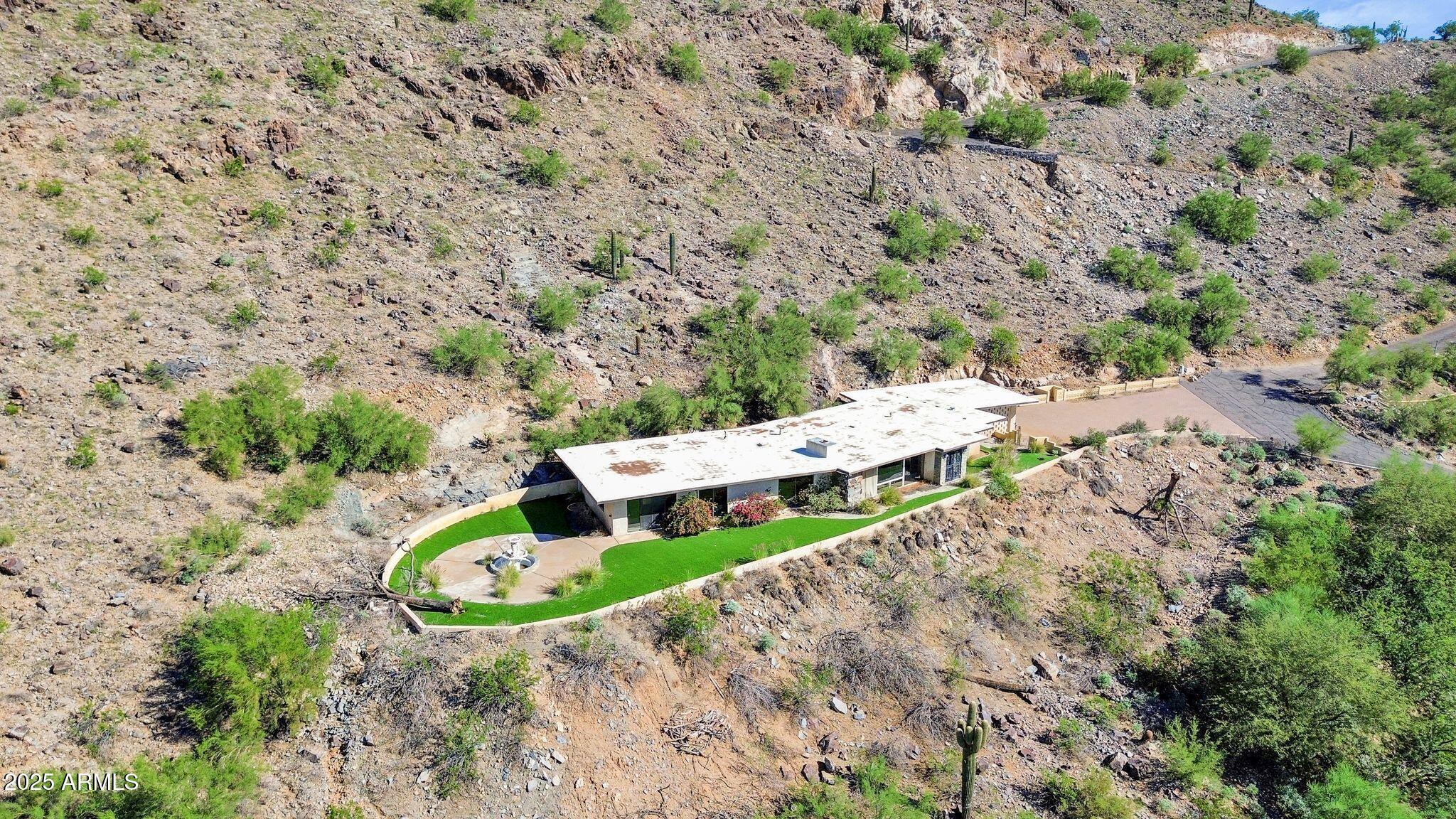 7040 North Invergordon Road Paradise Valley, AZ 85253 - Photo 7 of 11 a view of yard with large trees and wooden fence