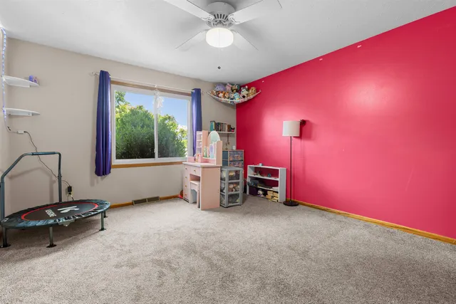 a view of a room with window and a ceiling fan