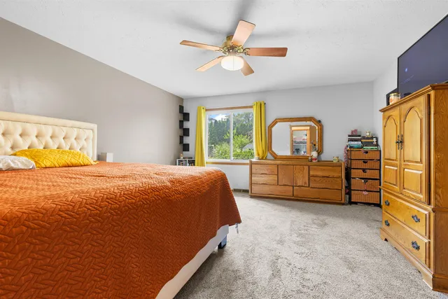 a bedroom with a bed dresser and a window